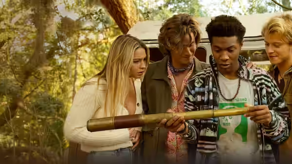 Sarah Cameron, John B, Pope and JJ examining an object outdoors