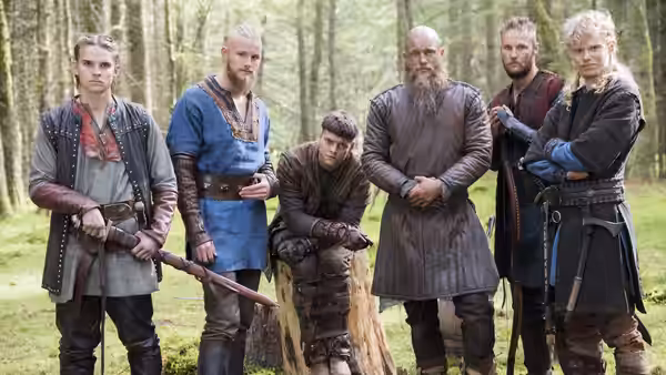 Ragnar Lothbrok (Travis Fimmel) and his sons standing in a forest