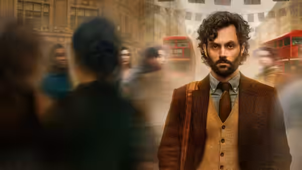 Joe Goldberg (Penn Badgley) walking through a crowded city street