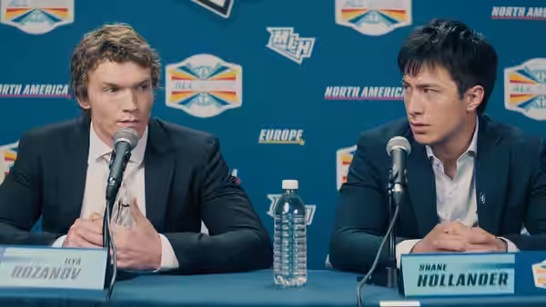 Ilya Rozanov and Shane Hollander speak at a press conference table