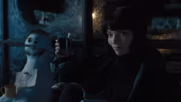 Drasa (Anya Taylor-Joy) raising a glass beside a strange figure