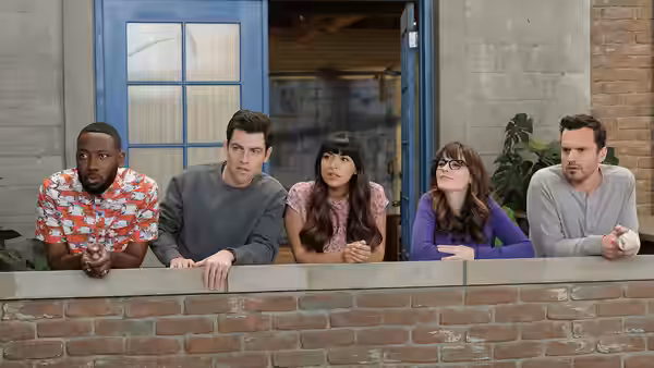 Winston, Nick, Jess and friends leaning on a brick balcony wall