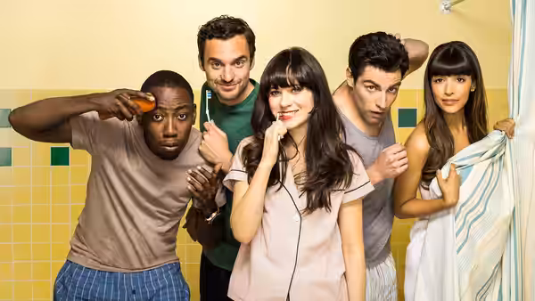 Winston (Lamorne Morris) holding a bottle as friends gather in the bathroom