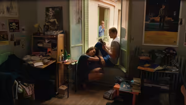 Electra (Aomi Muyock) crouching by a doorway as Murphy (Karl Glusman) sits nearby
