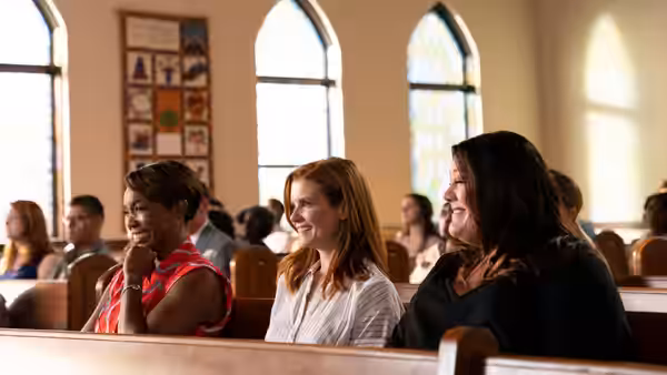 Helen Decatur (Heather Headley), Maddie Townsend (Joanna Garcia) and Dana Sue Sullivan (Brooke Elliott) laughing together in church
