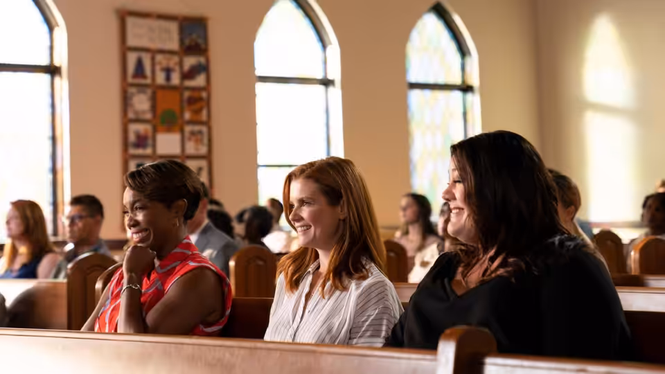 Helen Decatur (Heather Headley), Maddie Townsend (Joanna Garcia) and Dana Sue Sullivan (Brooke Elliott) laughing together in church