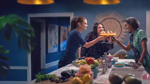 Maddie Townsend (Joanna Garcia), Dana Sue Sullivan (Brooke Elliott) and Helen Decatur (Heather Headley) toasting with pizza in a kitchen