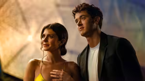 Poppy (Emily Bader) and Alex (Tom Blyth) standing together outdoors at dusk