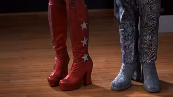 Red glitter platform boots beside silver snakeskin boots