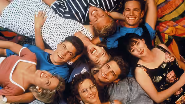 Group of friends lying on the ground smiling upwards