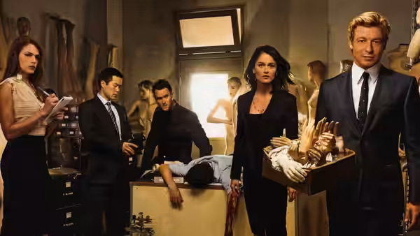 Patrick Jane (Simon Baker) stands with Teresa Lisbon (Robin Tunney) in a morgue