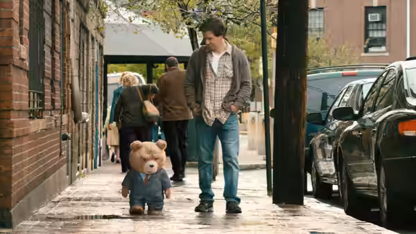 John Bennett (Mark Wahlberg) walks with Ted along a city sidewalk