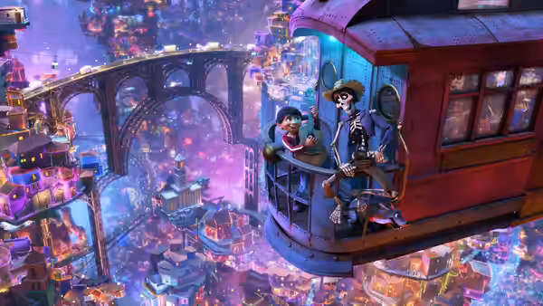 Miguel and a skeleton ride a tram above the colorful nighttime city