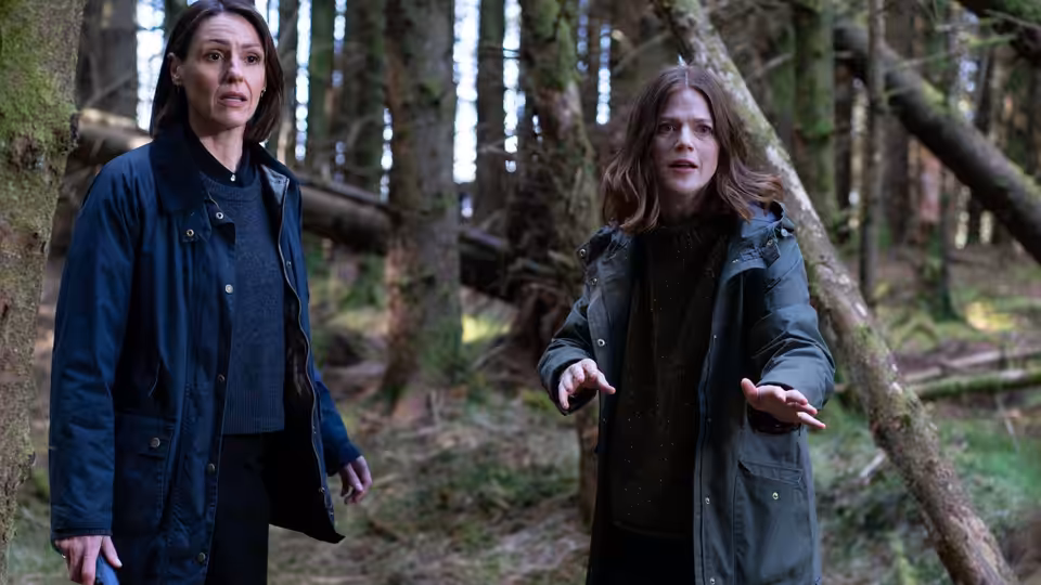 DCI Amy Silva (Suranne Jones) and DS Kirsten Longacre (Rose Leslie) stand among trees