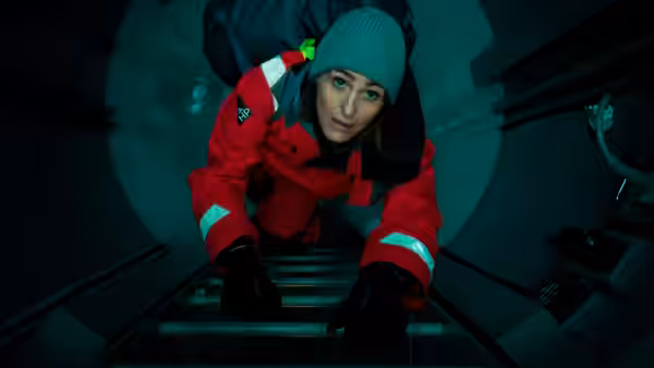 DS Kirsten Longacre (Rose Leslie) climbs a metal ladder in a confined space