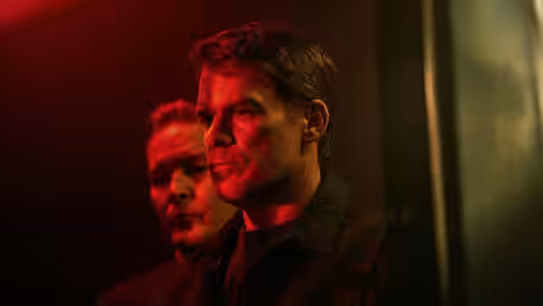 Dexter Morgan (Michael C. Hall) with blood on his face under red light