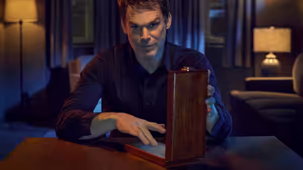 Dexter Morgan (Michael C. Hall) opening a wooden box on a table