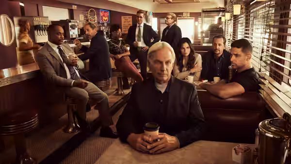 Leroy Jethro Gibbs (Mark Harmon) holding coffee in a retro diner