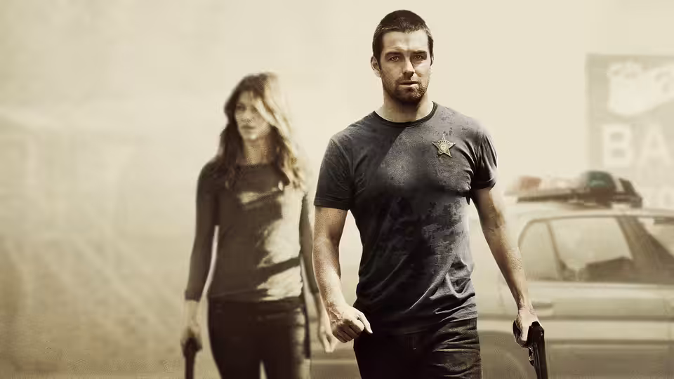 Lucas Hood (Antony Starr) and Carrie Hopewell (Ivana Miličević) holding guns near a car