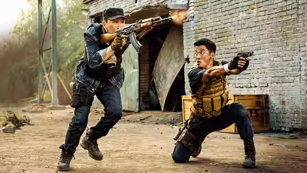 Leng Feng (Wu Jing) kneels and aims a pistol as an armed man fires beside him