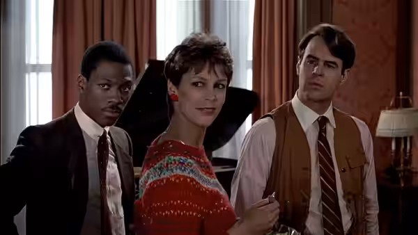 Billy Ray Valentine (Eddie Murphy), Ophelia (Jamie Lee Curtis) and Louis Winthorpe III (Dan Aykroyd) indoors