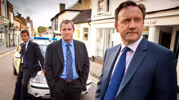 Tom Barnaby (John Nettles) on a village street with two colleagues