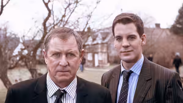 Tom Barnaby (John Nettles) standing beside a colleague in suits outdoors