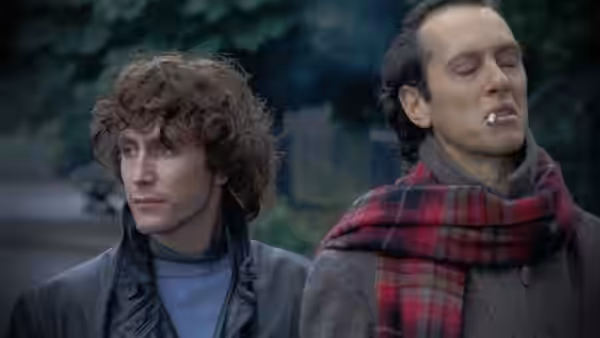 Withnail (Richard E. Grant) with a cigarette and Marwood (Paul McGann) in close-up