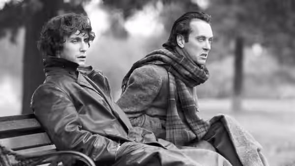 Withnail (Richard E. Grant) and Marwood (Paul McGann) sitting on a park bench