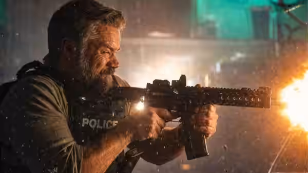 Matt Damon firing an assault rifle during a nighttime shootout