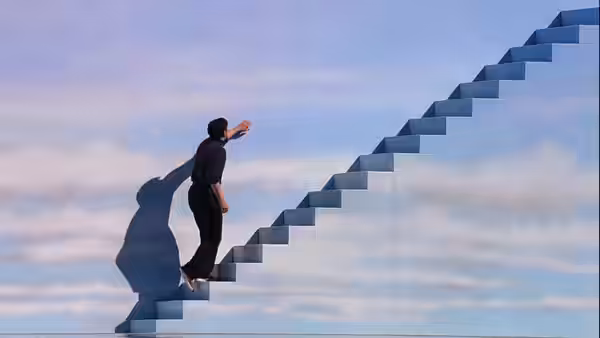 Truman Burbank (Jim Carrey) climbing a floating staircase into the sky