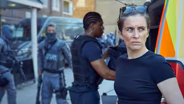 Lana Washington (Vicky McClure) standing with police officers near emergency vehicles