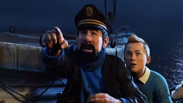 Captain Haddock points ahead while Tintin watches aboard a ship at night