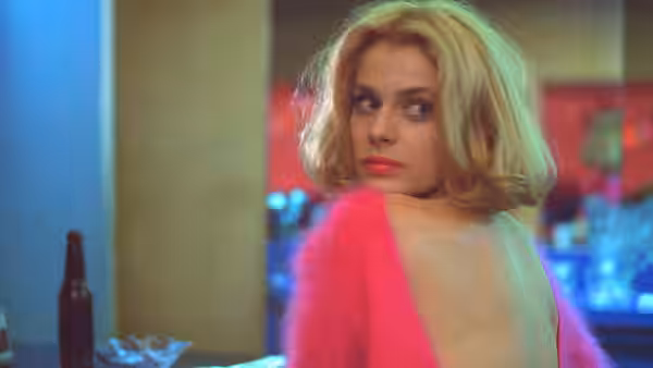 Jane (Nastassja Kinski) glancing back over her shoulder in a pink sweater