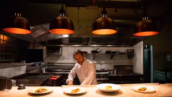 Andy Jones (Stephen Graham) plates dishes at the pass in the restaurant kitchen