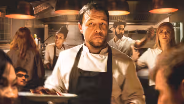 Andy Jones (Stephen Graham) walking through a busy professional kitchen