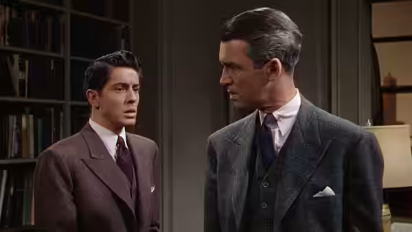 Kenneth Lawrence (Douglas Dick) faces Rupert Cadell (James Stewart) in the apartment library