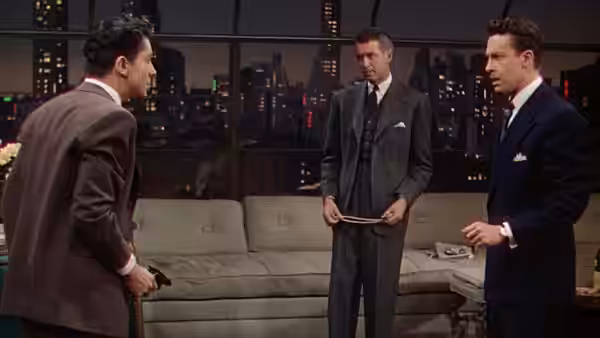 Brandon Shaw (John Dall), Phillip Morgan (Farley Granger), and Rupert Cadell (James Stewart) gather in the apartment living room