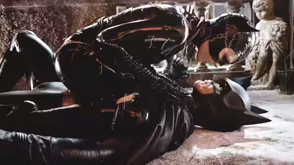 Catwoman (Michelle Pfeiffer) straddling Batman (Michael Keaton) on the floor during a fight