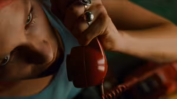 Lola (Franka Potente) holding a red telephone receiver to her ear