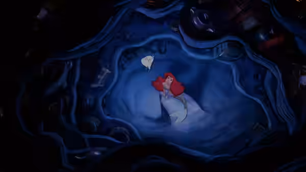Ariel floating in a dark cave while holding a white object
