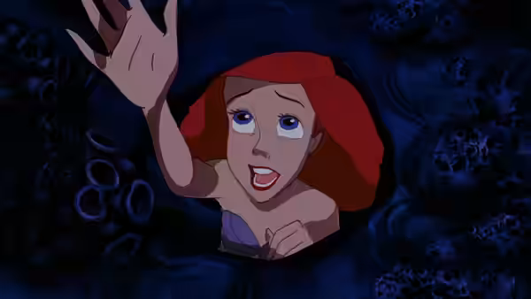 Ariel peeking from a dark crevice with one hand raised