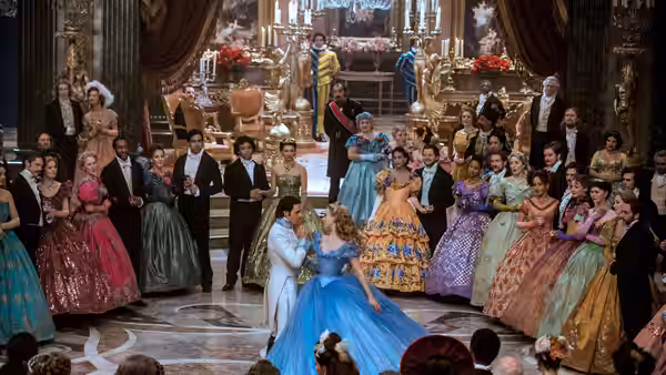 Cinderella (Lily James) dances with the Prince at a crowded royal ball