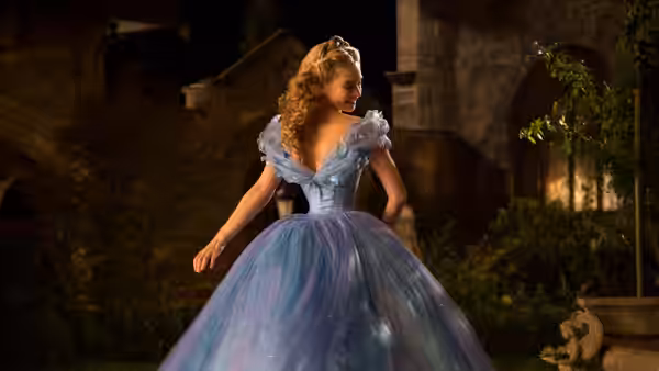 Cinderella (Lily James) turns in her blue gown in a palace garden