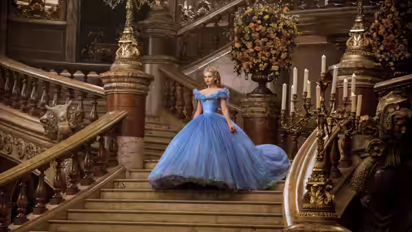 Cinderella (Lily James) descends the palace staircase in her blue ball gown