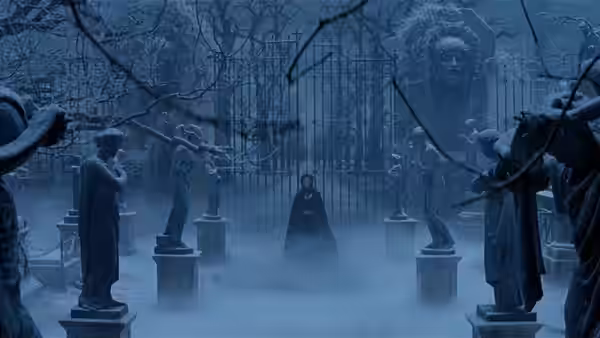 Christine in a black cloak standing in a foggy cemetery at night