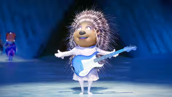 Hedgehog holding a blue guitar while standing on a stage