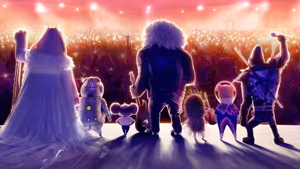 Group of animals standing on stage facing a large audience