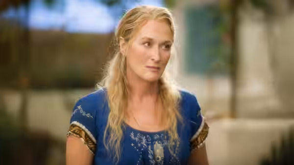 Donna Sheridan (Meryl Streep) stands outside looking to her left