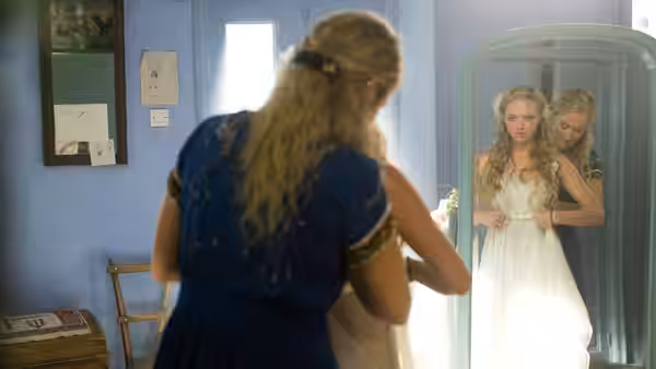 Donna (Meryl Streep) adjusts Sophie's wedding dress before a mirror